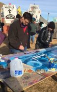 Photograph of art making in the Standing Rock camp